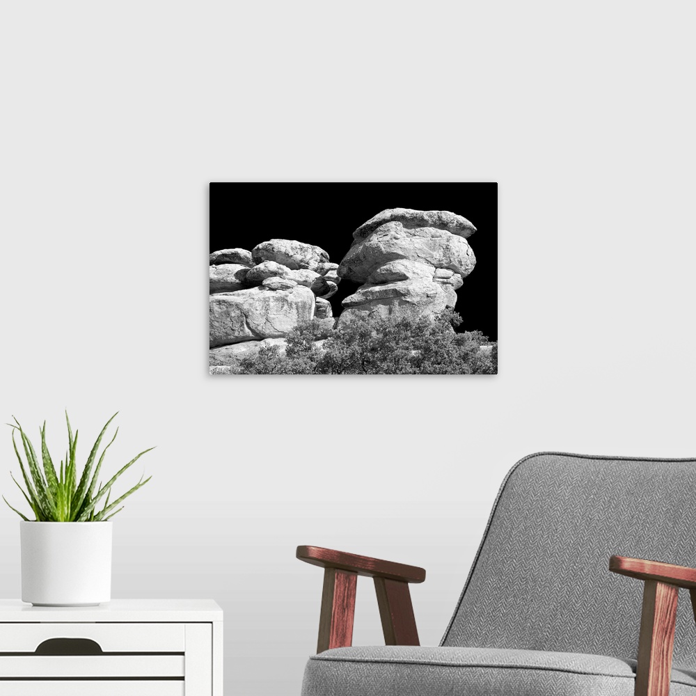 A modern room featuring Black and white photograph of stacked rock formations.