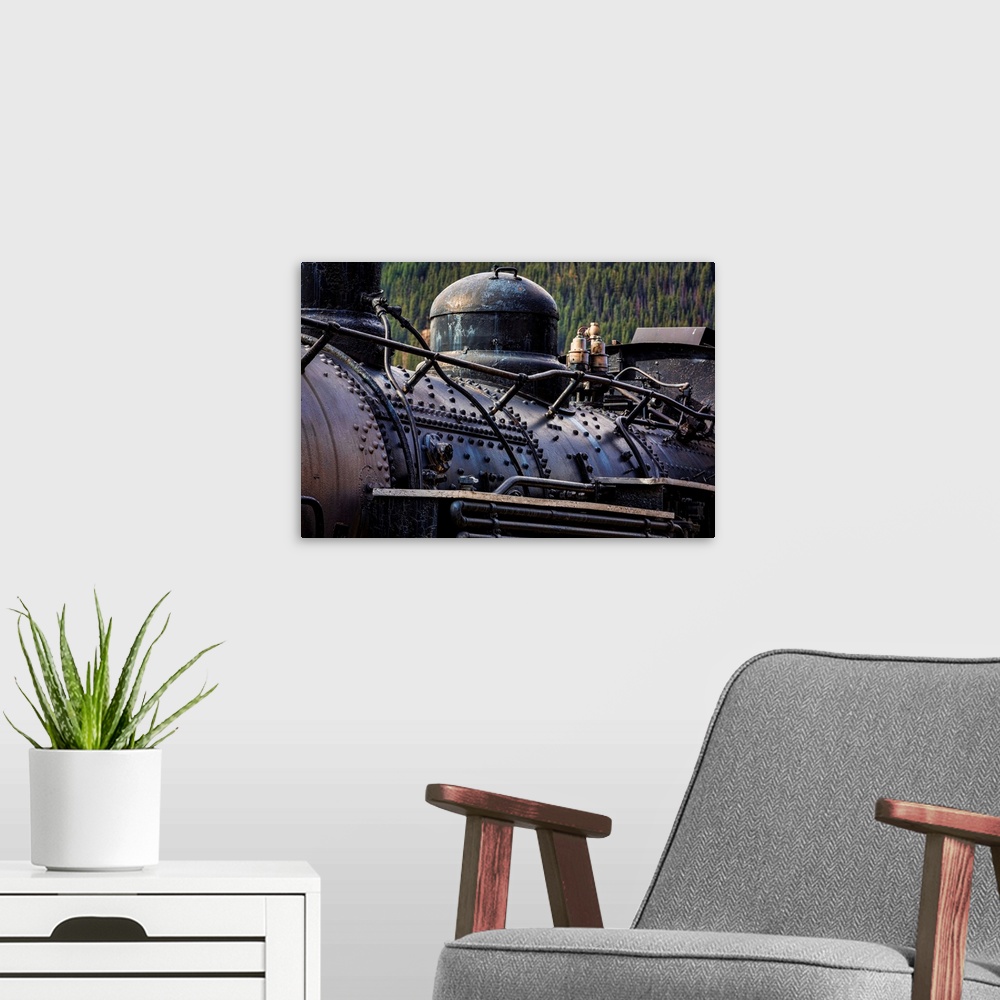 A modern room featuring Photograph of an old train engine in a rail yard.