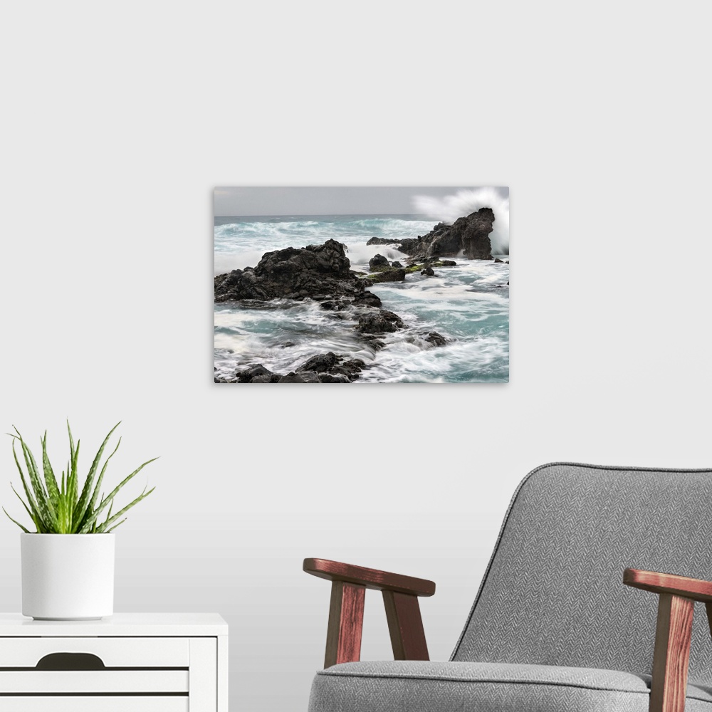 A modern room featuring Photograph of waves crashing on large rocks at Ho'okipa beach in Hawaii.