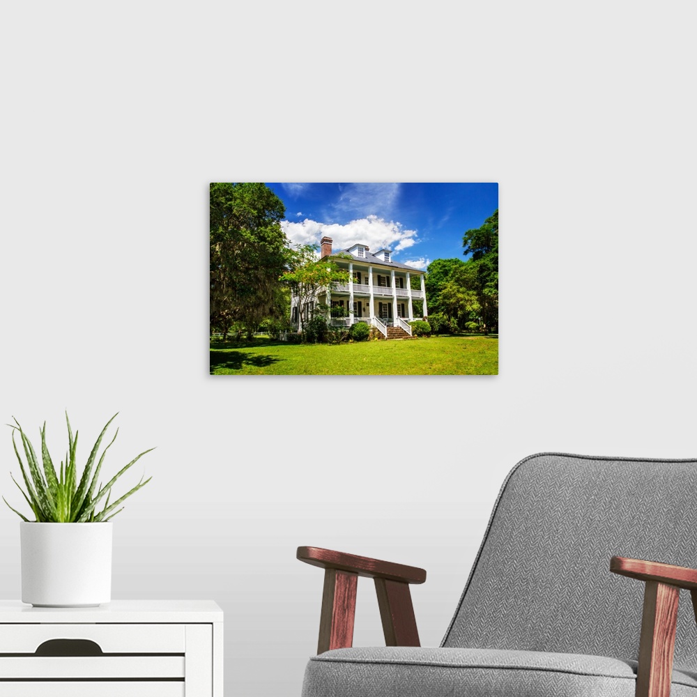 A modern room featuring Photograph of the front of Hopsewee Plantation in South Carolina.