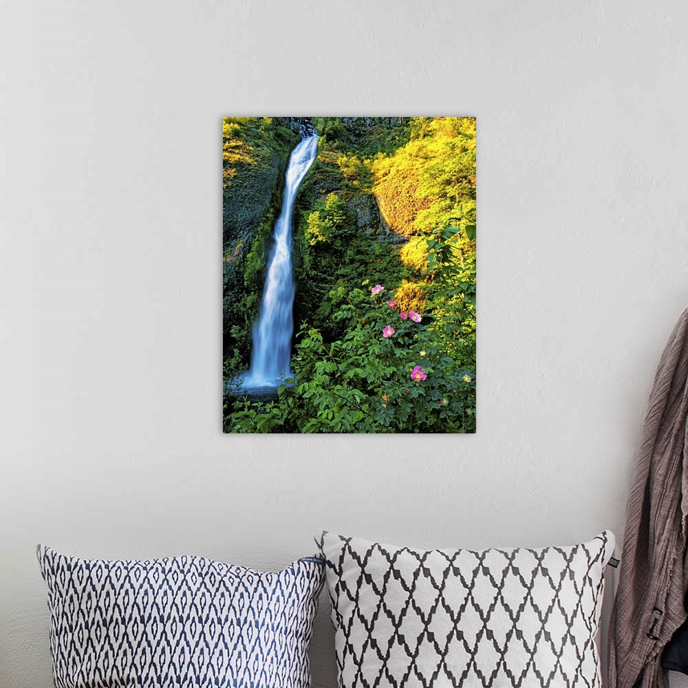 A bohemian room featuring A small waterfall near bright flowers in a forest in Oregon.