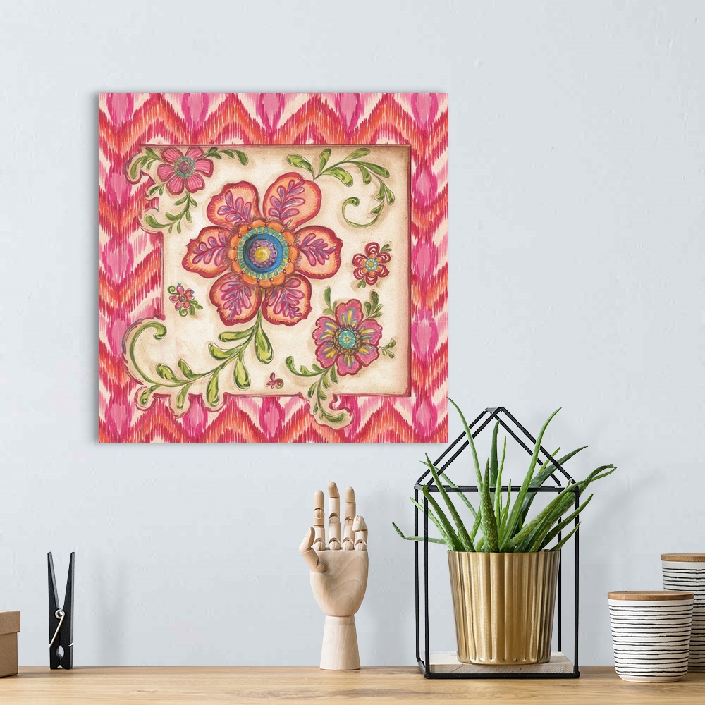 A bohemian room featuring Square painting of colorful flowers with an ikat designed frame in shades of pink.