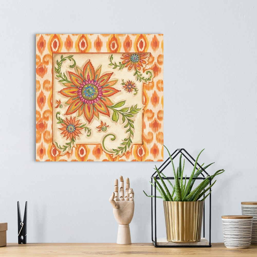 A bohemian room featuring Square painting of colorful flowers with an ikat designed frame in shades of orange and yellow.