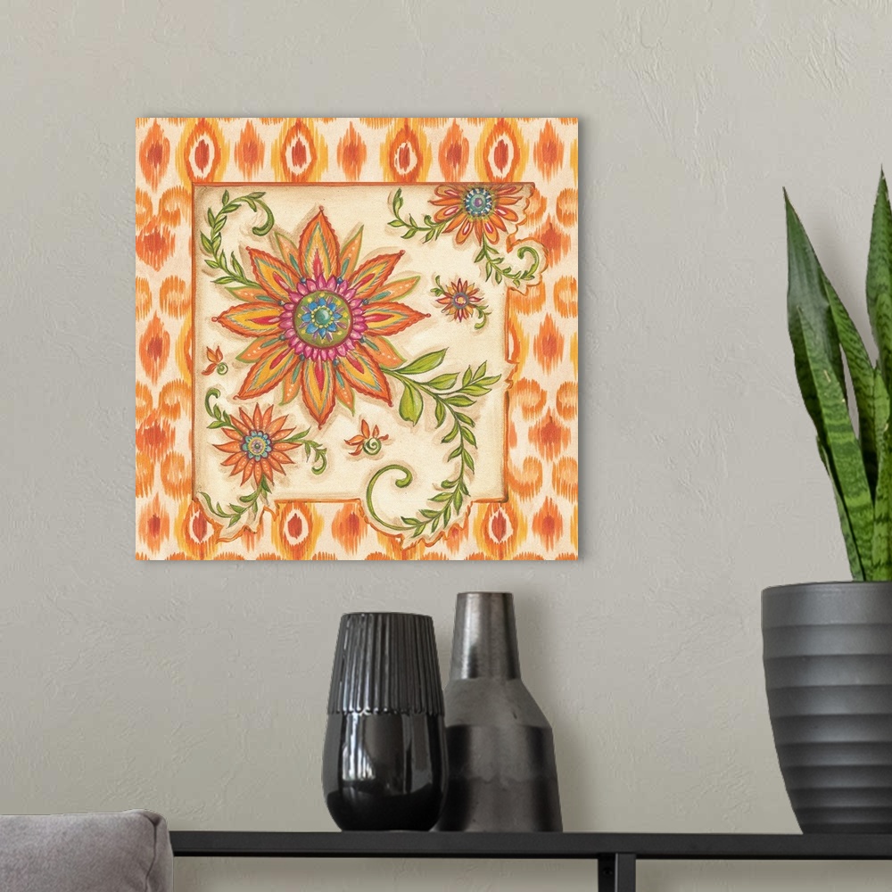A modern room featuring Square painting of colorful flowers with an ikat designed frame in shades of orange and yellow.