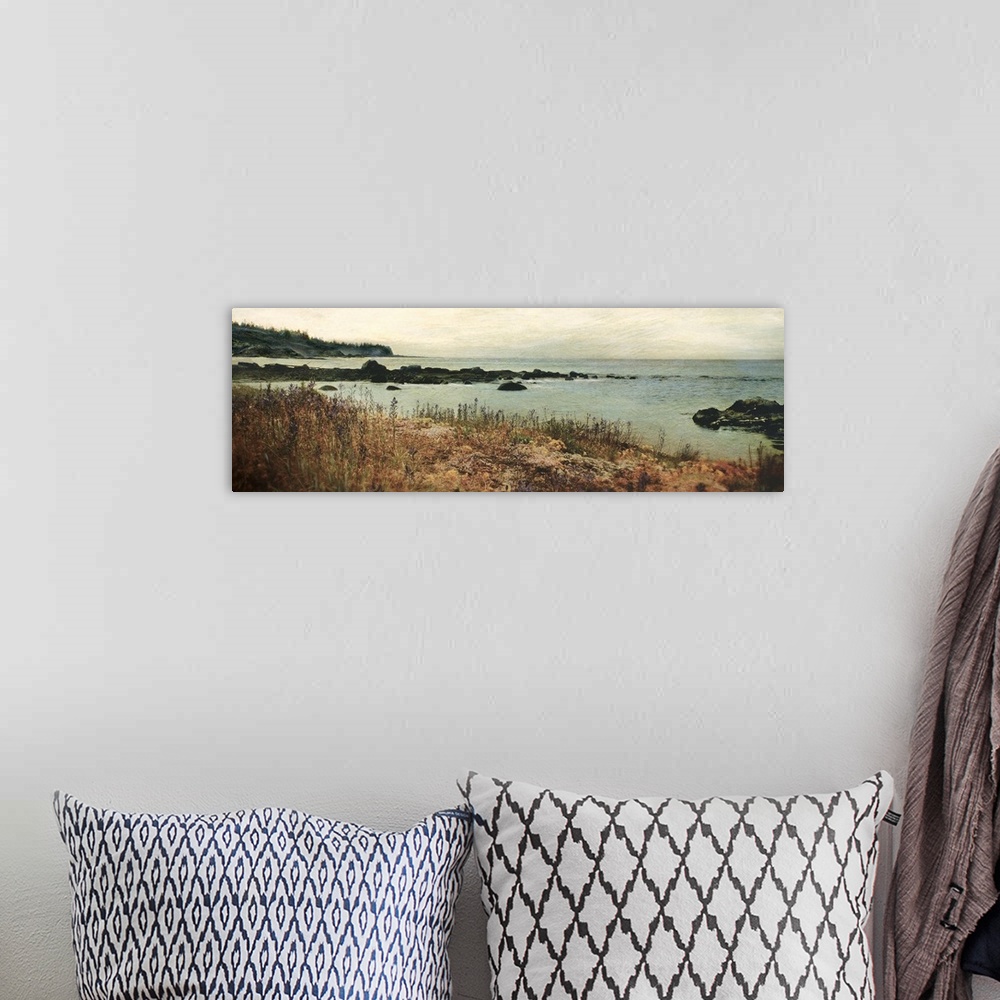 A bohemian room featuring Panoramic photograph on a giant wall hanging of the grassy shore on an island, overlooking rocks ...