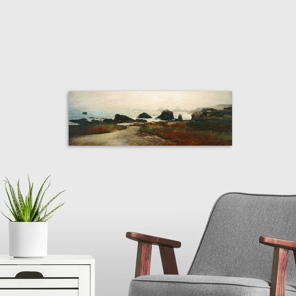 A modern room featuring Panoramic photograph displays patches of grass and sand on the edge of a rocky shoreline that has...