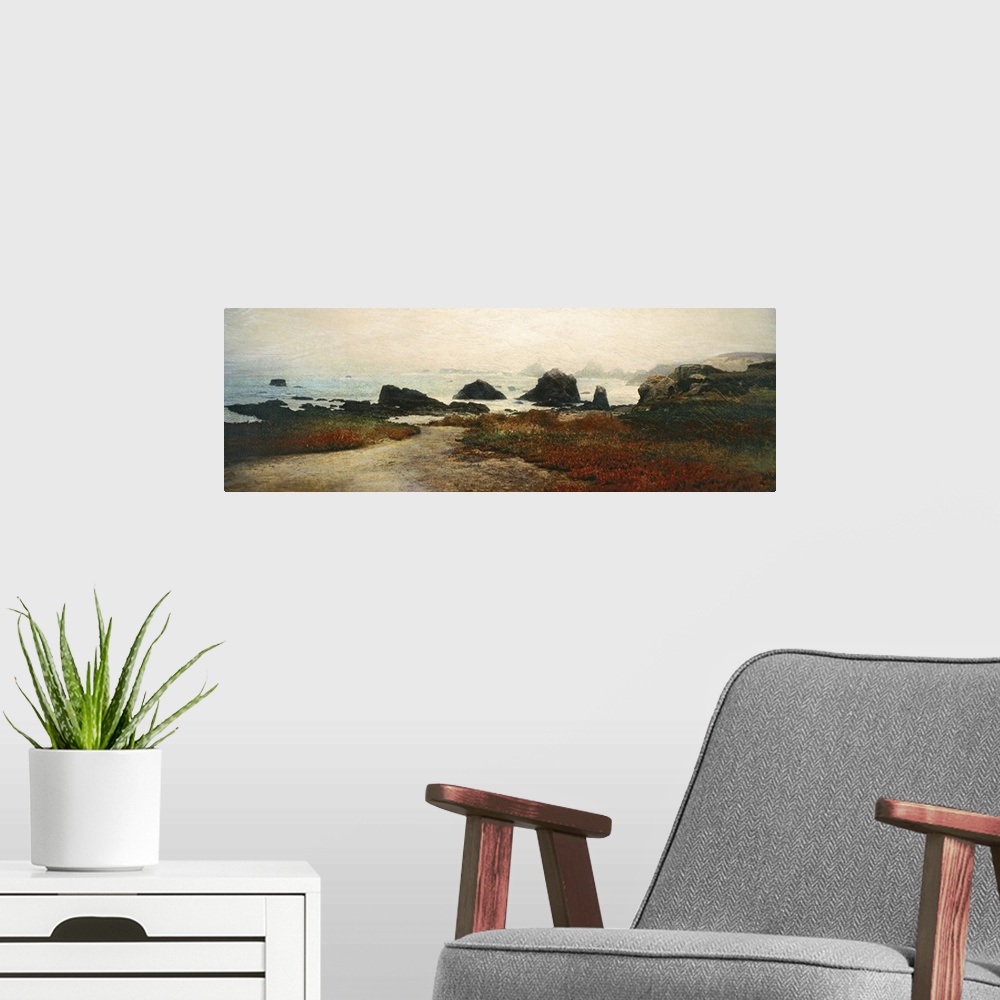 A modern room featuring Panoramic photograph displays patches of grass and sand on the edge of a rocky shoreline that has...