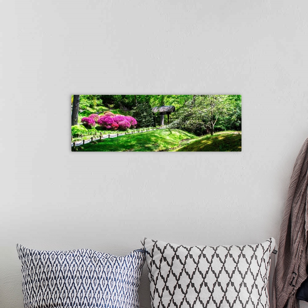 A bohemian room featuring Panoramic photograph of a Japanese garden with bright pink and purple flowers and lush greenery.