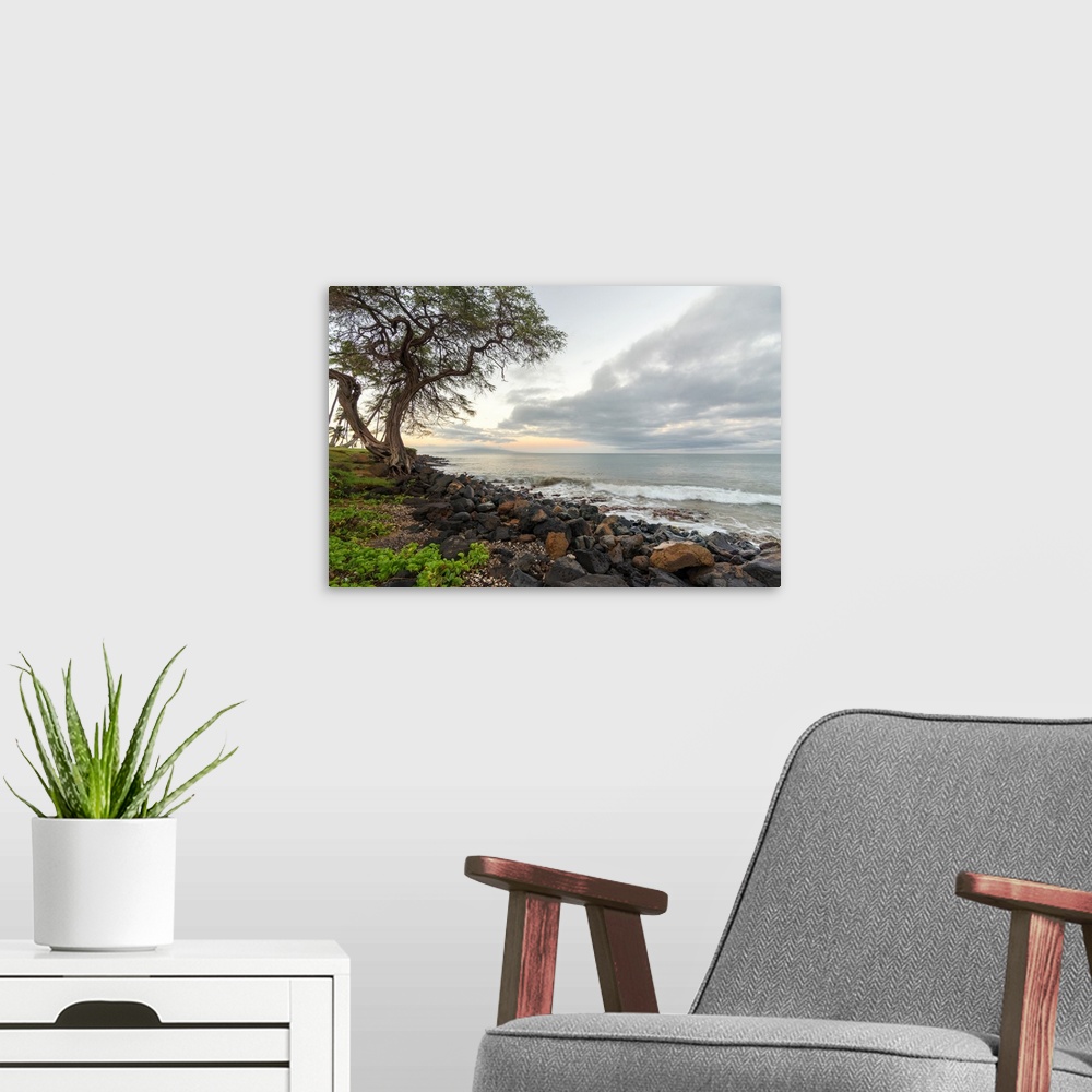 A modern room featuring Landscape photograph of a sunrise over the rocky shoreline in Kihei, Hawaii.