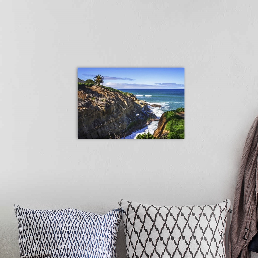 A bohemian room featuring Landscape photograph of the hilly seashore in La Jolla, California.