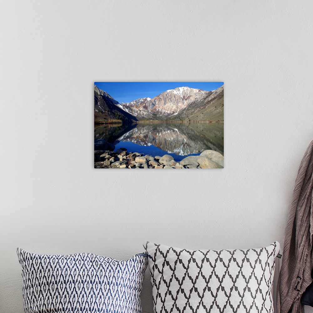 A bohemian room featuring Photograph of mountains reflecting off of Lake Laurel.