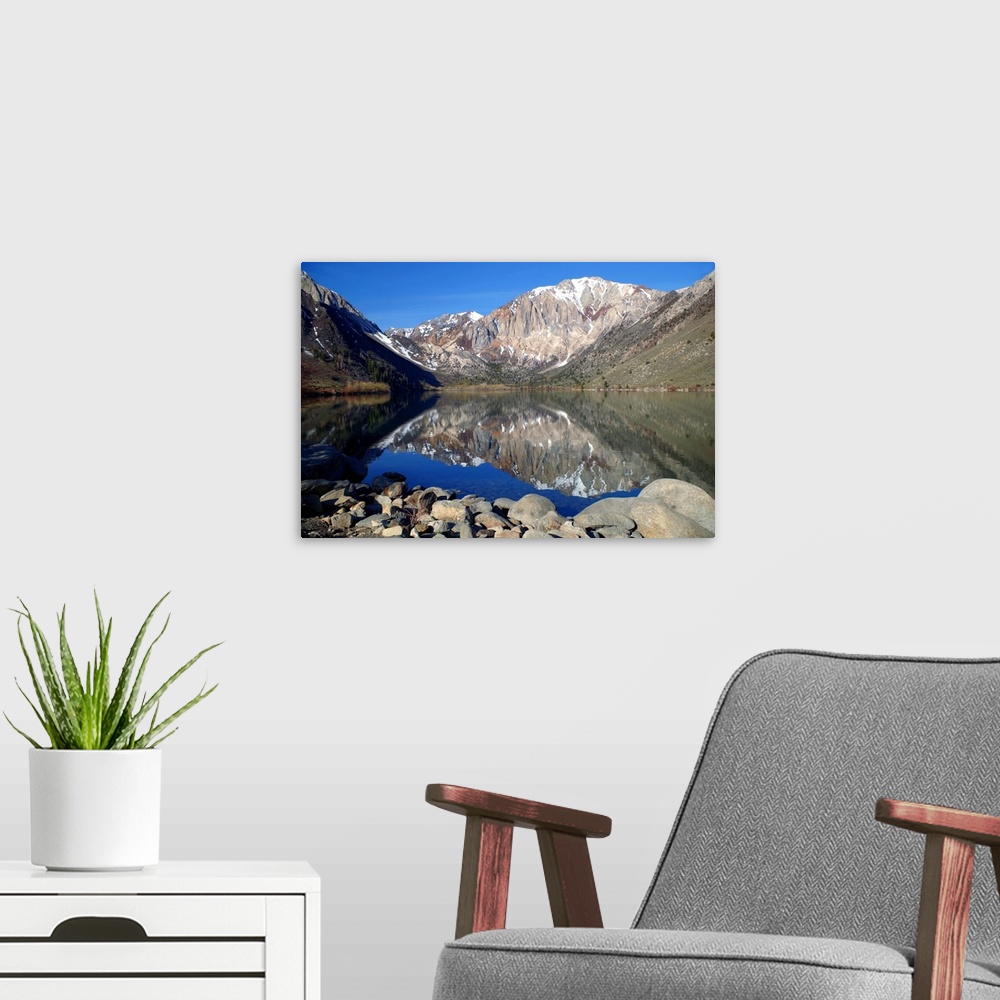 A modern room featuring Photograph of mountains reflecting off of Lake Laurel.