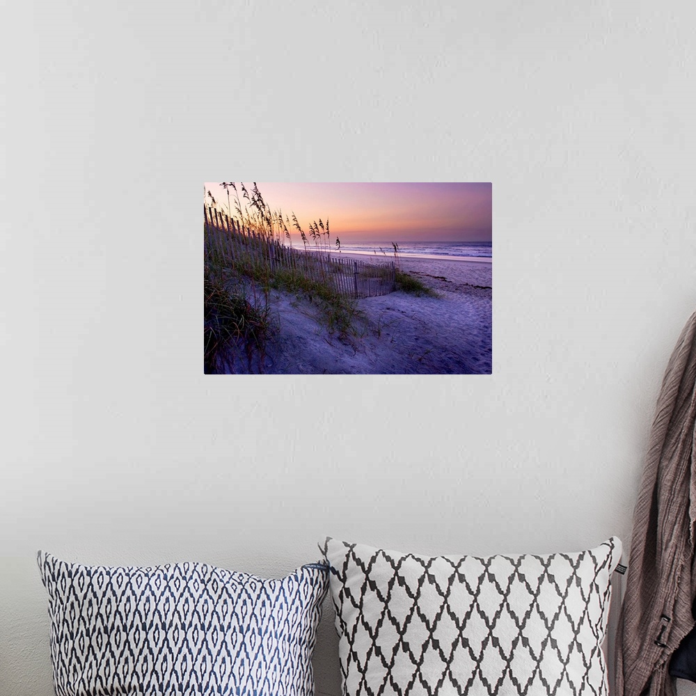 A bohemian room featuring Big canvas photo art of a beach with dunes and sea oats on the left and the shore meeting the oce...