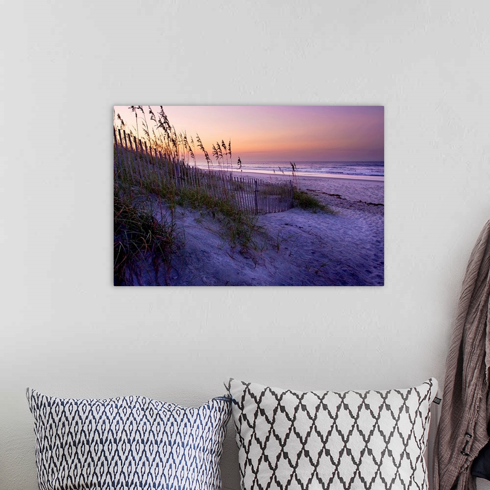 A bohemian room featuring Big canvas photo art of a beach with dunes and sea oats on the left and the shore meeting the oce...