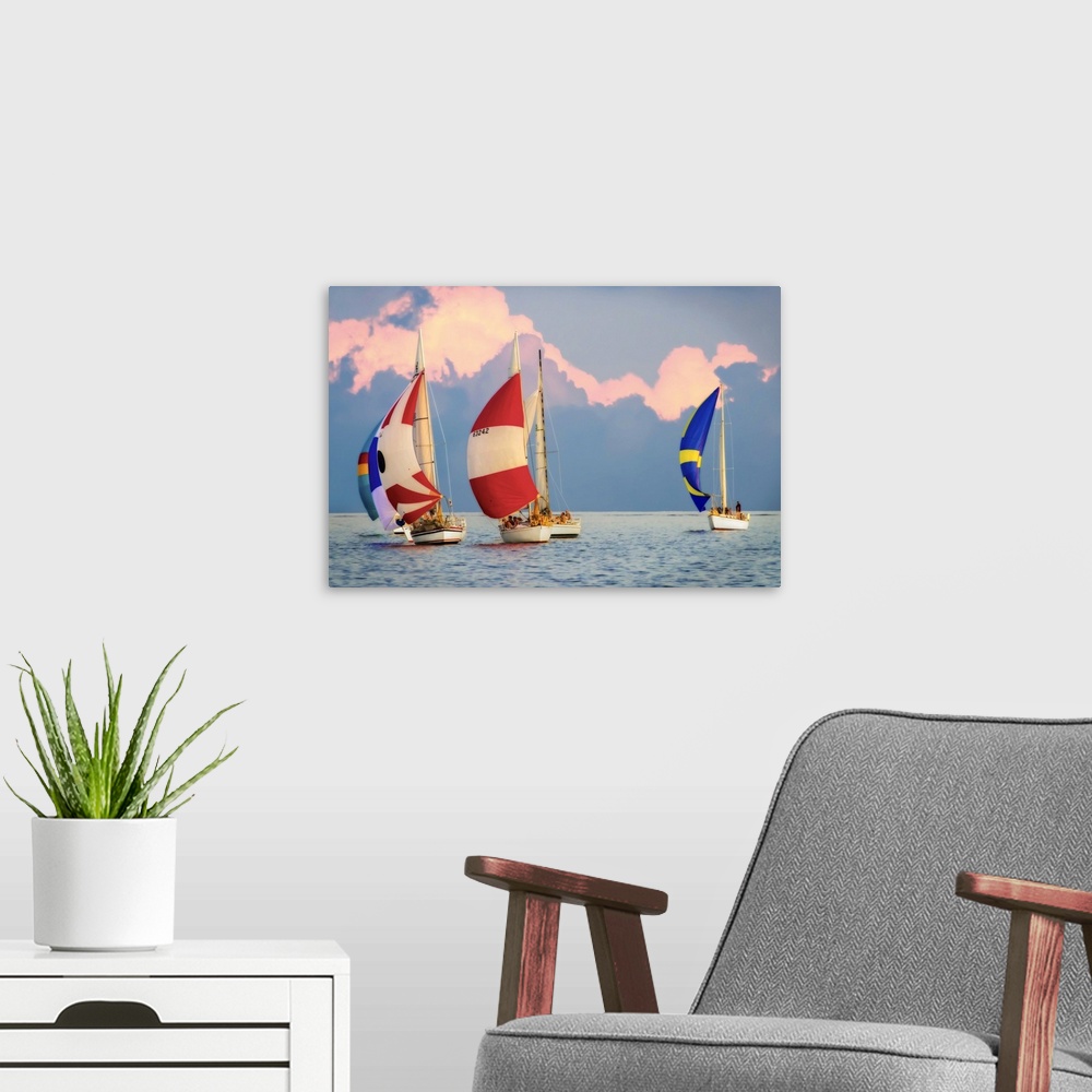 A modern room featuring Sailboats with colorful sails on the water with large clouds in the sky.