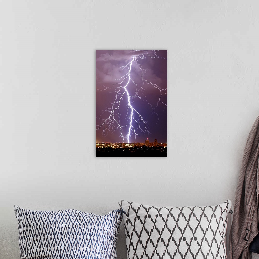 A bohemian room featuring Photograph of large lightning bolts striking in a purple sky above an Arizona city.
