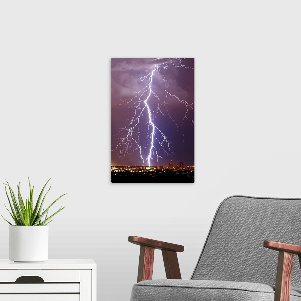 A modern room featuring Photograph of large lightning bolts striking in a purple sky above an Arizona city.