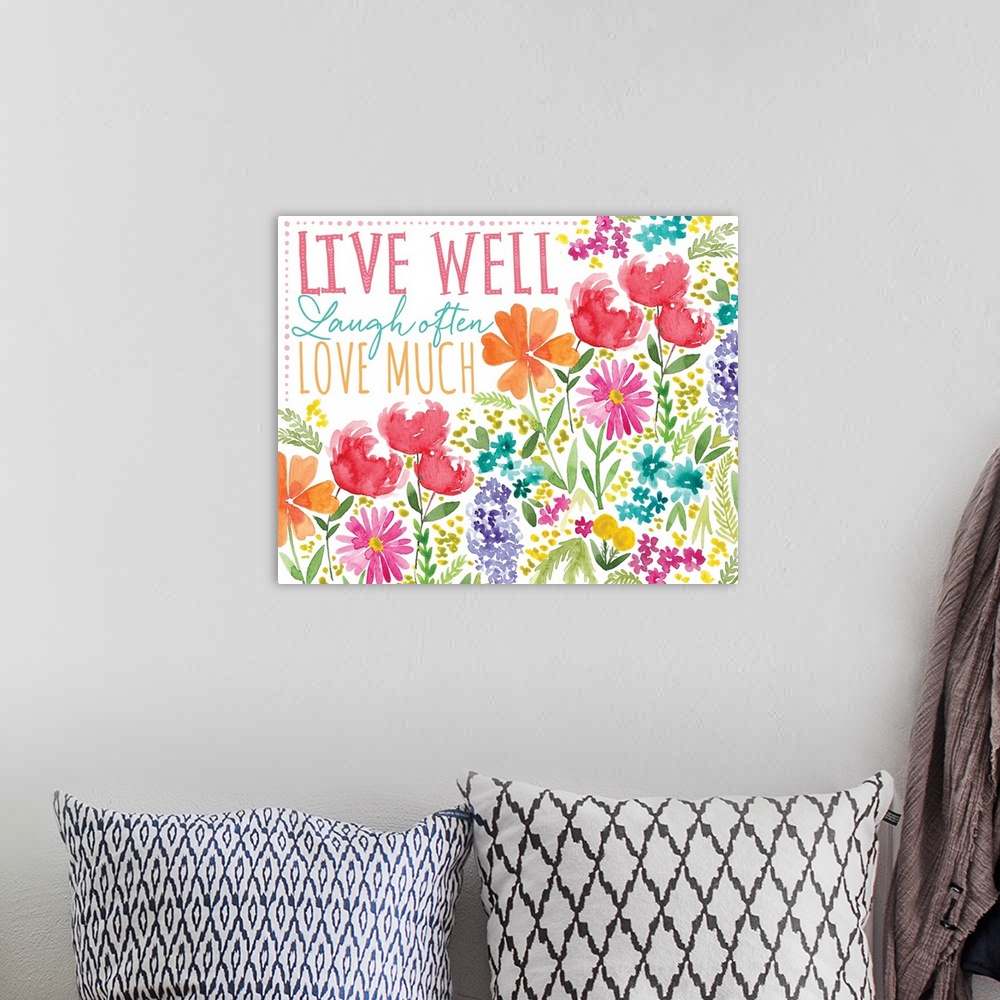 A bohemian room featuring "Live well, Laugh often, Love much" surrounded by watercolor flowers.