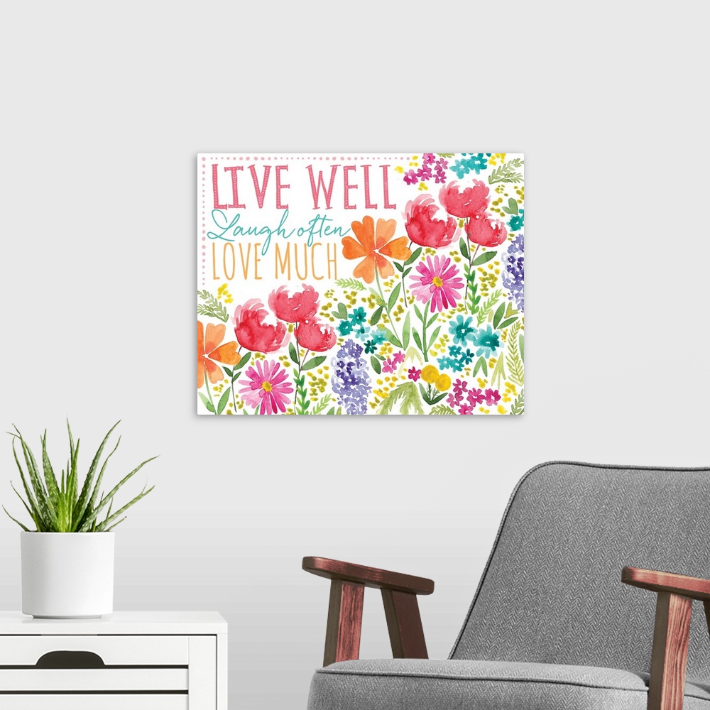 A modern room featuring "Live well, Laugh often, Love much" surrounded by watercolor flowers.