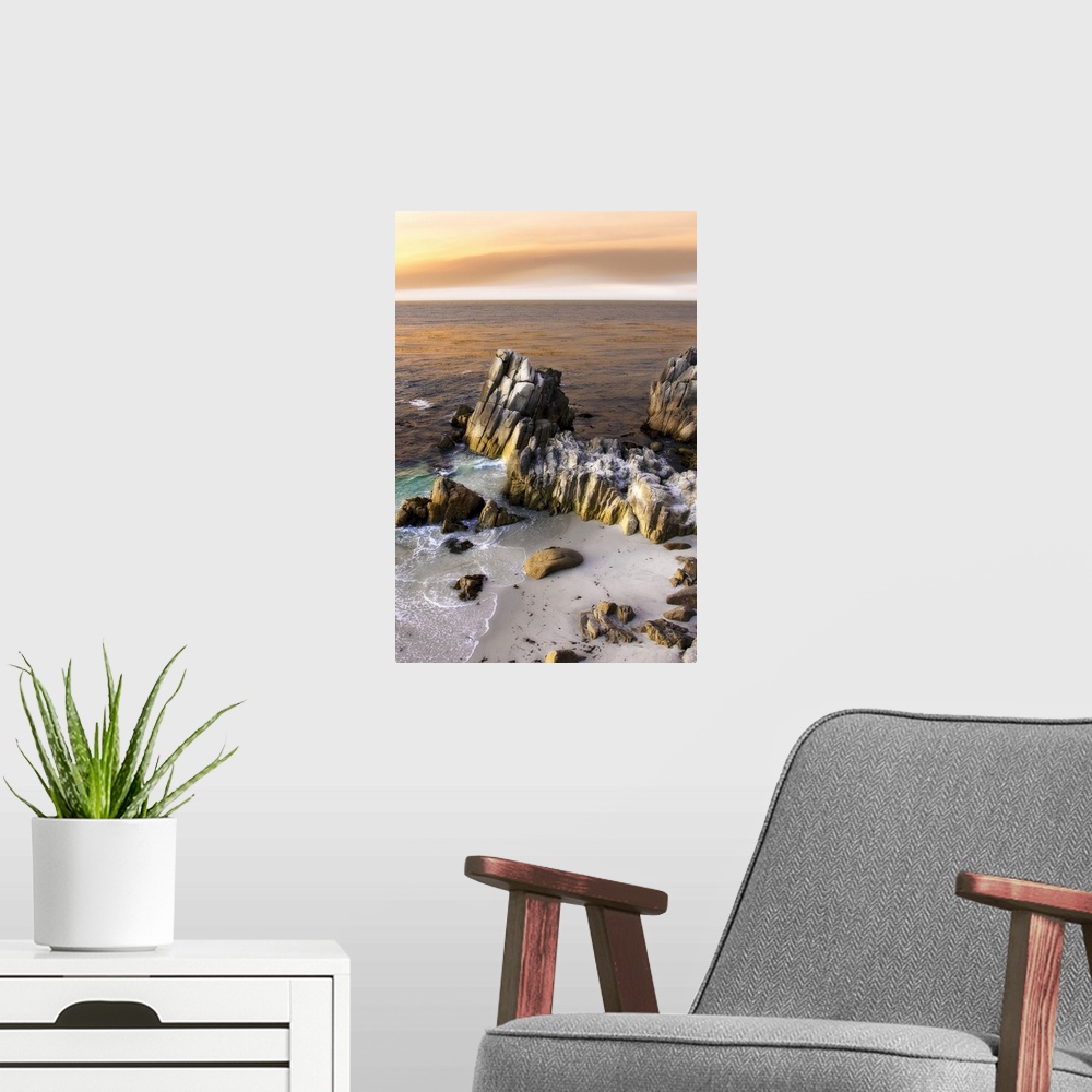 A modern room featuring Vertical photo on canvas of tall rocks sticking out of the ocean by the shoreline with sun set wa...