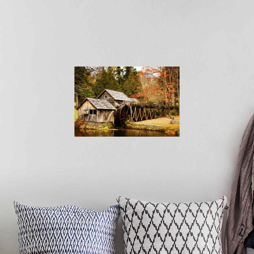 A bohemian room featuring An old wooden watermill in a forest in autumn.