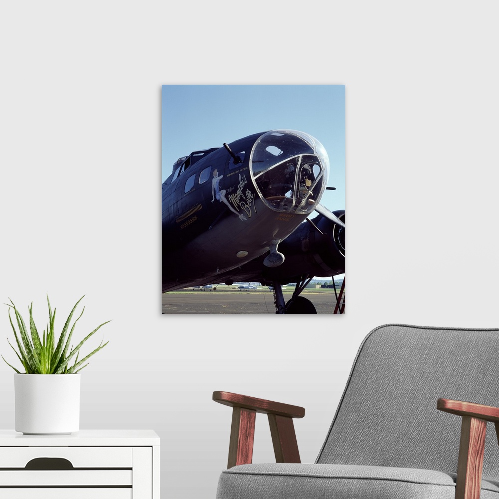 A modern room featuring Photograph of the front end of the Memphis Belle aircraft.