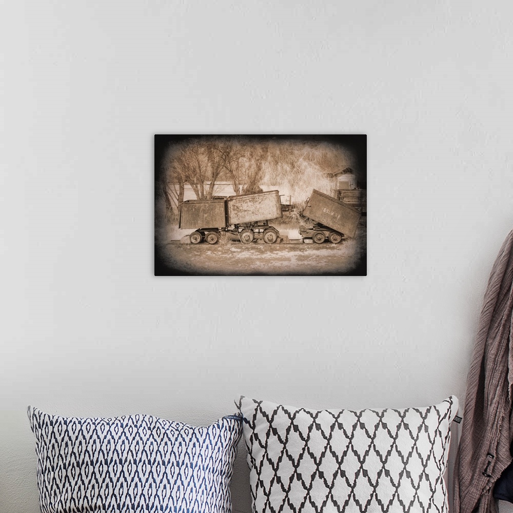 A bohemian room featuring Antique photograph of mine carts with a dark vignette.