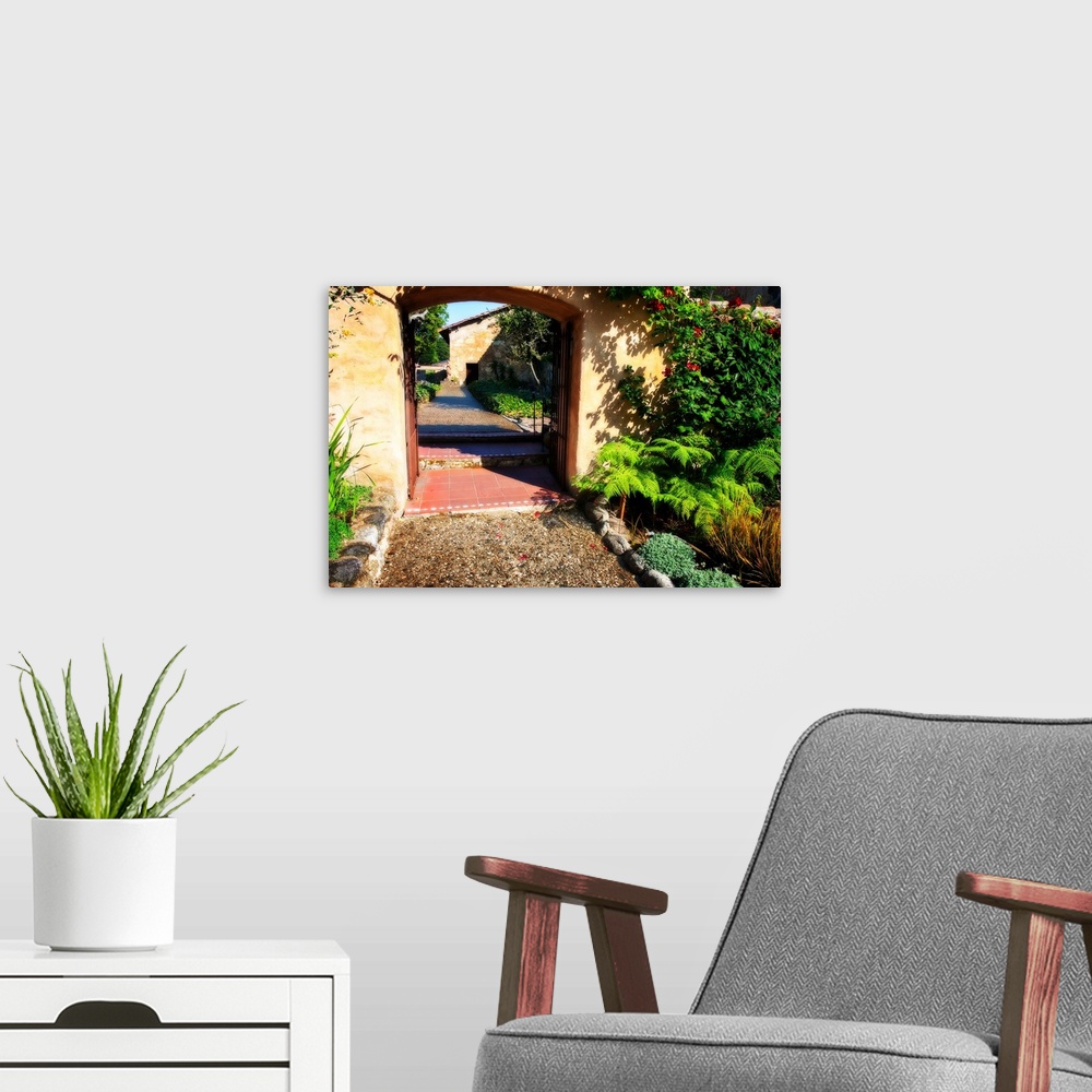A modern room featuring Landscape photograph of a pathway through an arch lined with greenery in Carmel, California.