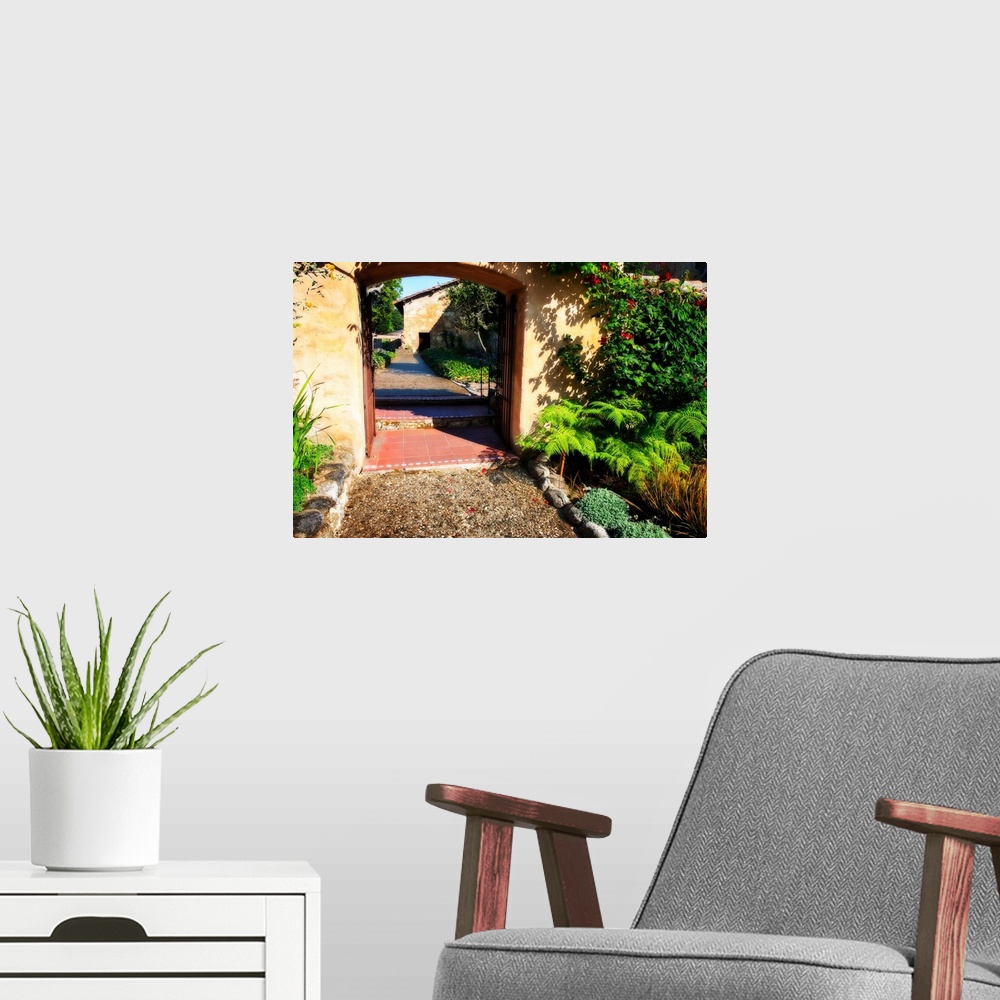A modern room featuring Landscape photograph of a pathway through an arch lined with greenery in Carmel, California.