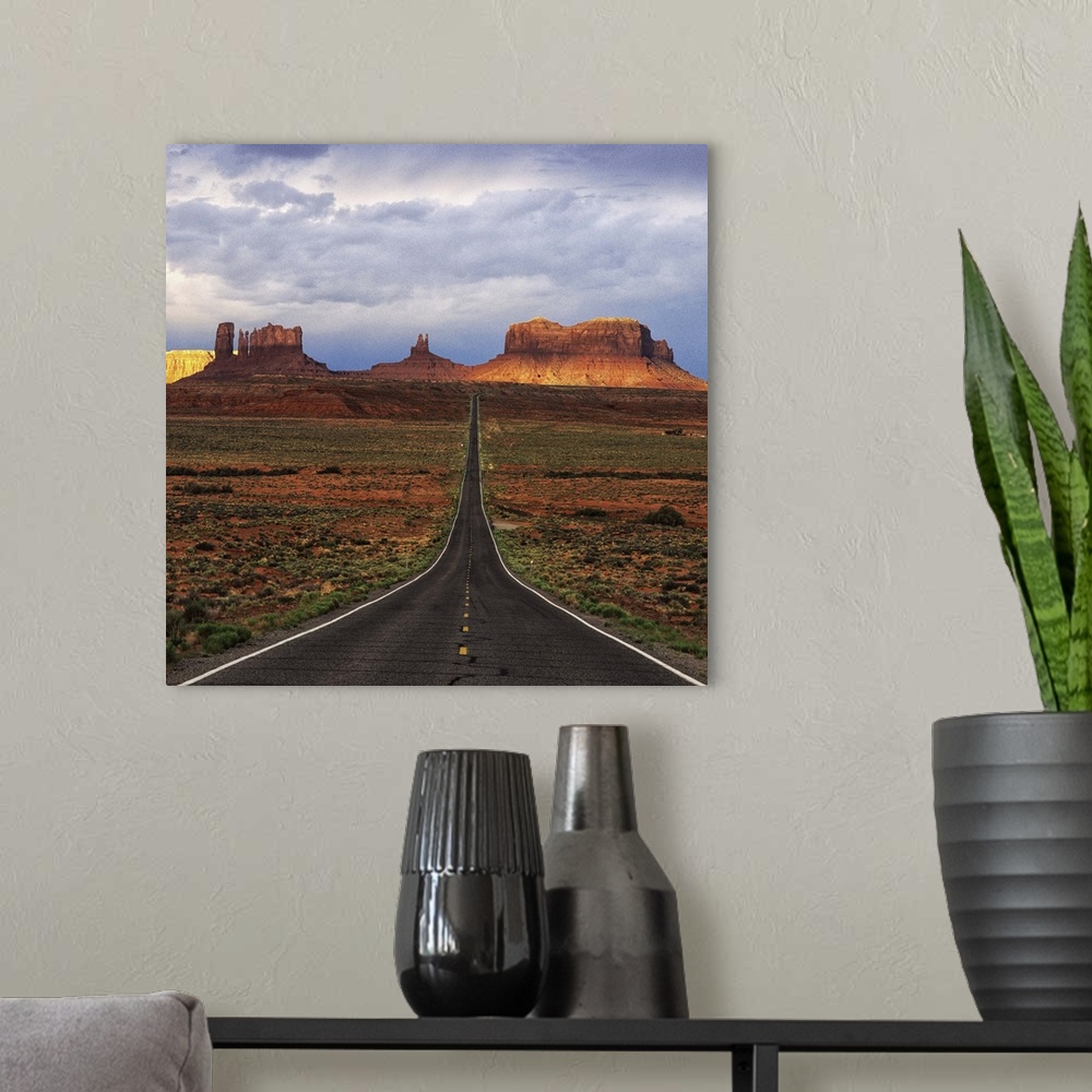 A modern room featuring A road leading towards the tall rock formations in Monument Valley, Arizona.