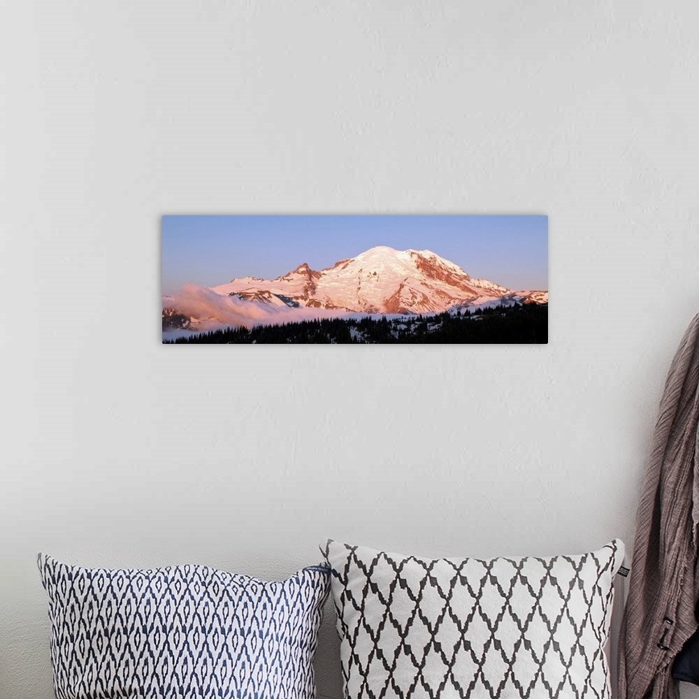 A bohemian room featuring Morning light making Mount Rainier appear slightly pink.