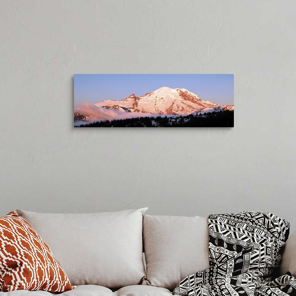 A bohemian room featuring Morning light making Mount Rainier appear slightly pink.