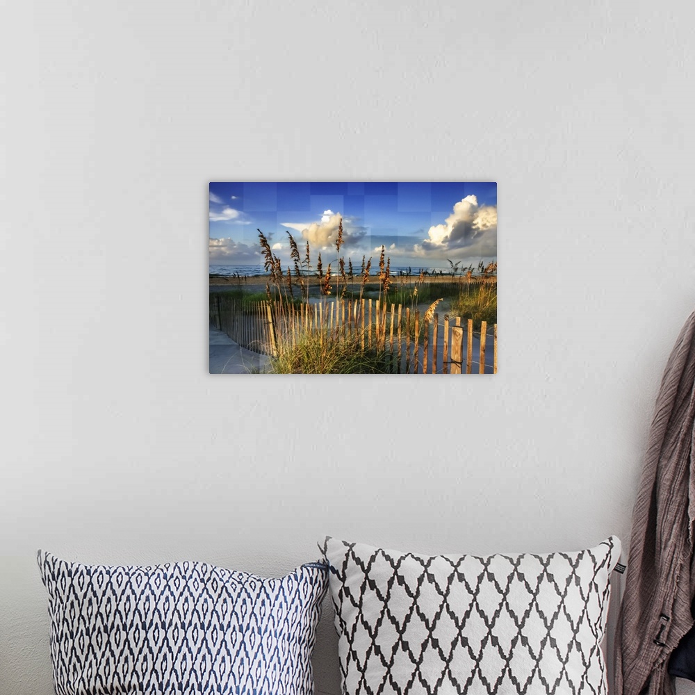 A bohemian room featuring Reeds along a fence on the beach, with square shapes in the sky.