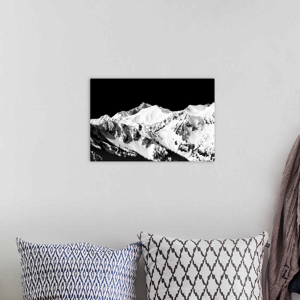 A bohemian room featuring Black and white photograph of snowy mountain peaks.