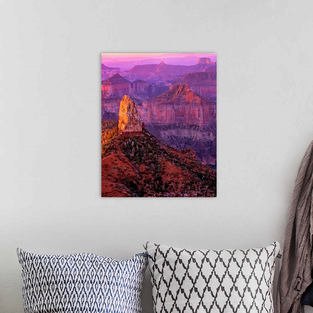 A bohemian room featuring Tall rock formations in purple and red light in Arizona.