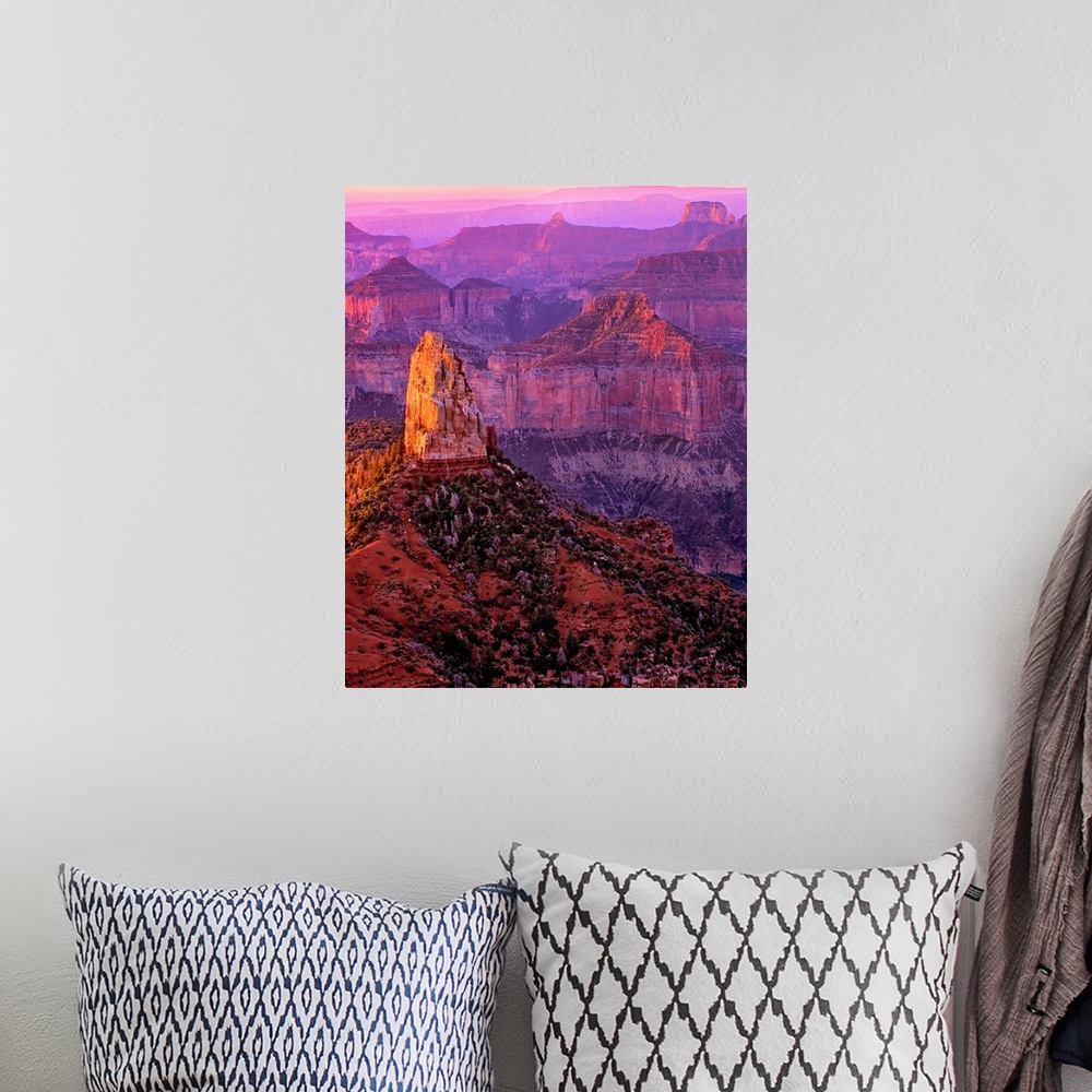 A bohemian room featuring Tall rock formations in purple and red light in Arizona.