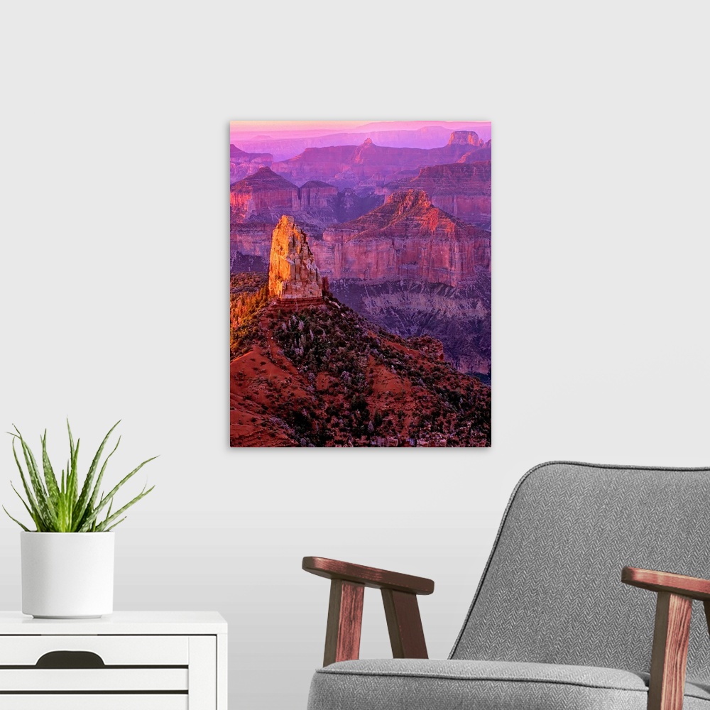 A modern room featuring Tall rock formations in purple and red light in Arizona.