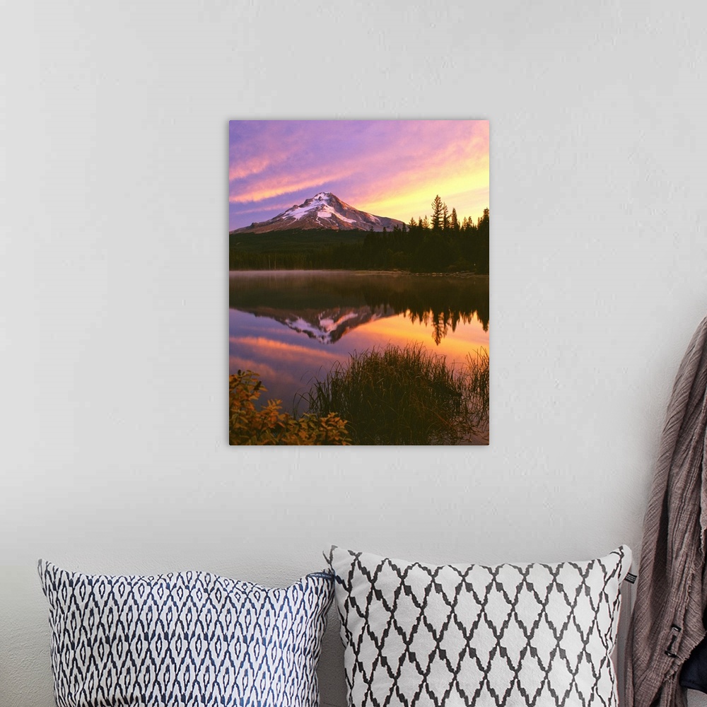 A bohemian room featuring Mount Hood at sunset reflected in a lake.