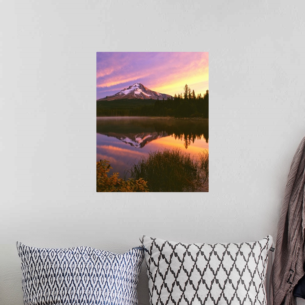 A bohemian room featuring Mount Hood at sunset reflected in a lake.