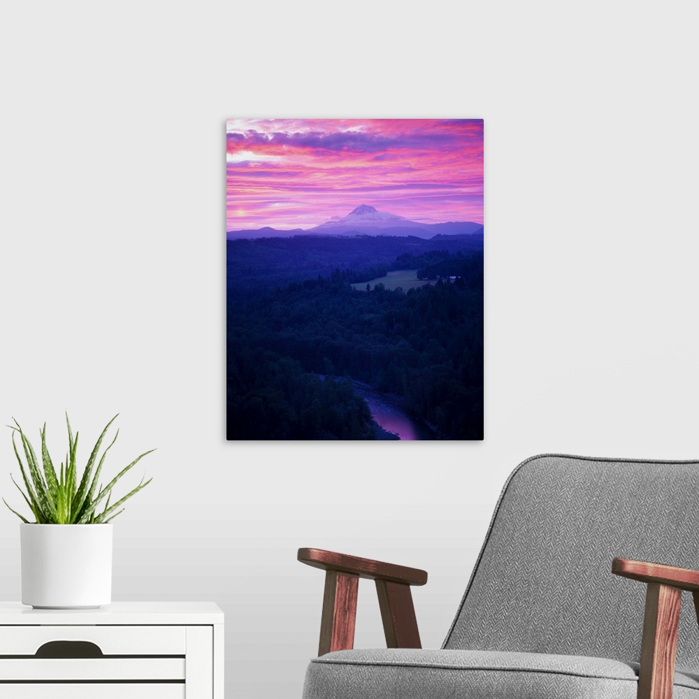 A modern room featuring Purple clouds at sunset over Mount Hood covered in fog in the distance.