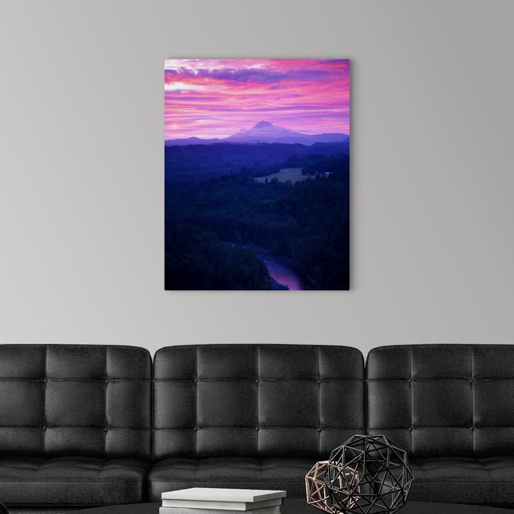 A modern room featuring Purple clouds at sunset over Mount Hood covered in fog in the distance.