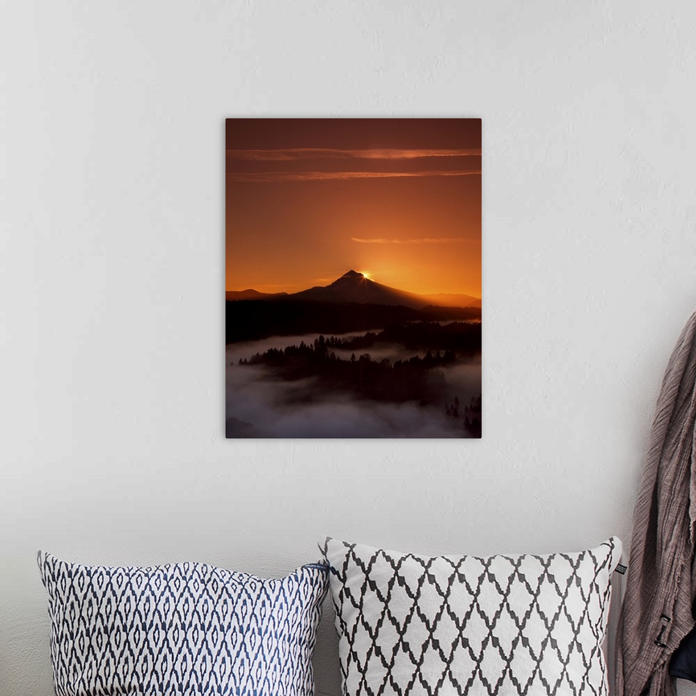 A bohemian room featuring The sun setting behind Mount Hood, with dense fog in the valley below.
