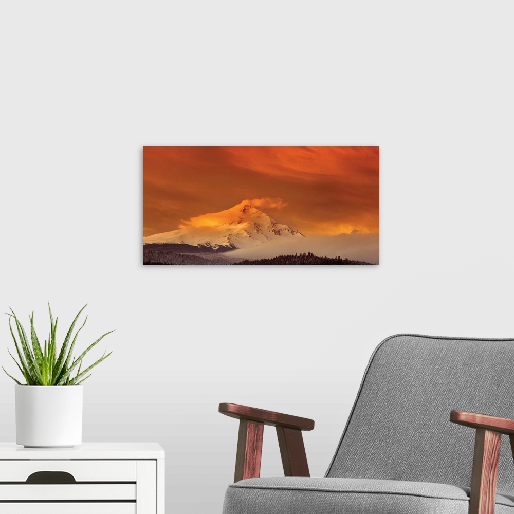 A modern room featuring Clouds covering the snowy peak of Mount Hood at sunset.