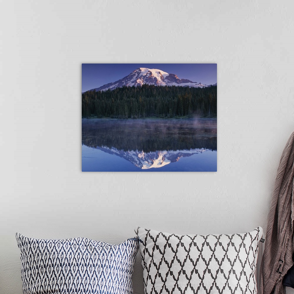 A bohemian room featuring Mount Rainier and the surrounding forests reflected in a lake, Washington.