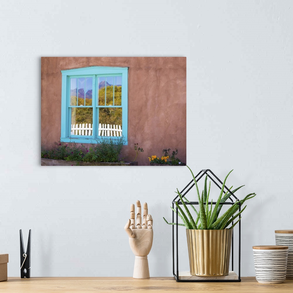 A bohemian room featuring Photograph of a colorful window pane in an adobe wall.