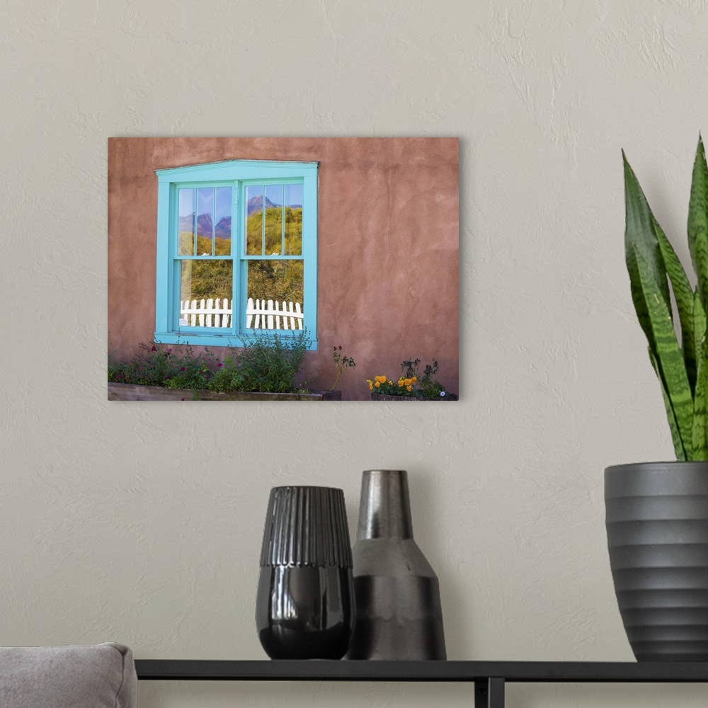 A modern room featuring Photograph of a colorful window pane in an adobe wall.