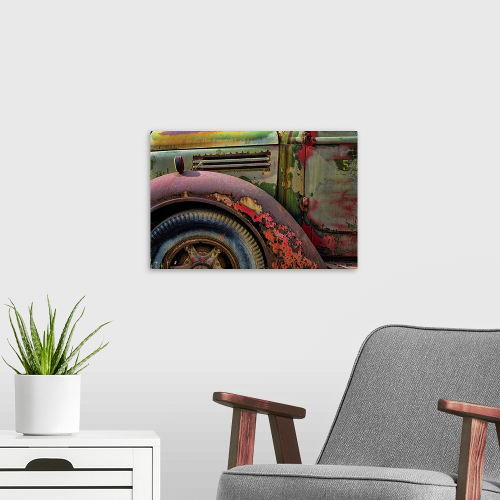 A modern room featuring A close up photo of weathered old parts of a vintage truck.
