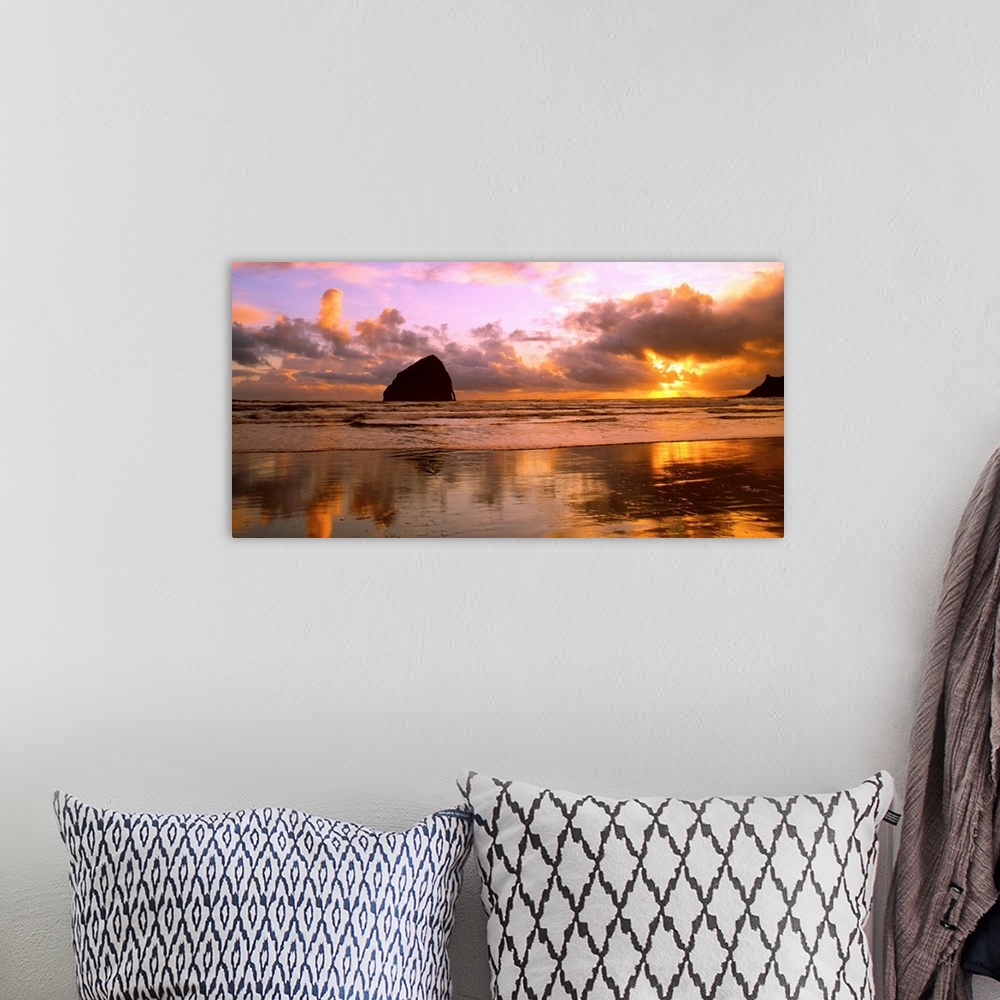 A bohemian room featuring Sea stacks on the beach silhouetted at sunset, Pacific City, Oregon.