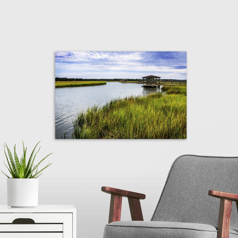 A modern room featuring A gazebo overlooking the water in a marsh.