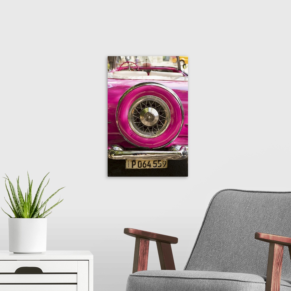 A modern room featuring Photograph of the spare tire case on the back of a vintage hot pink car in Cuba.